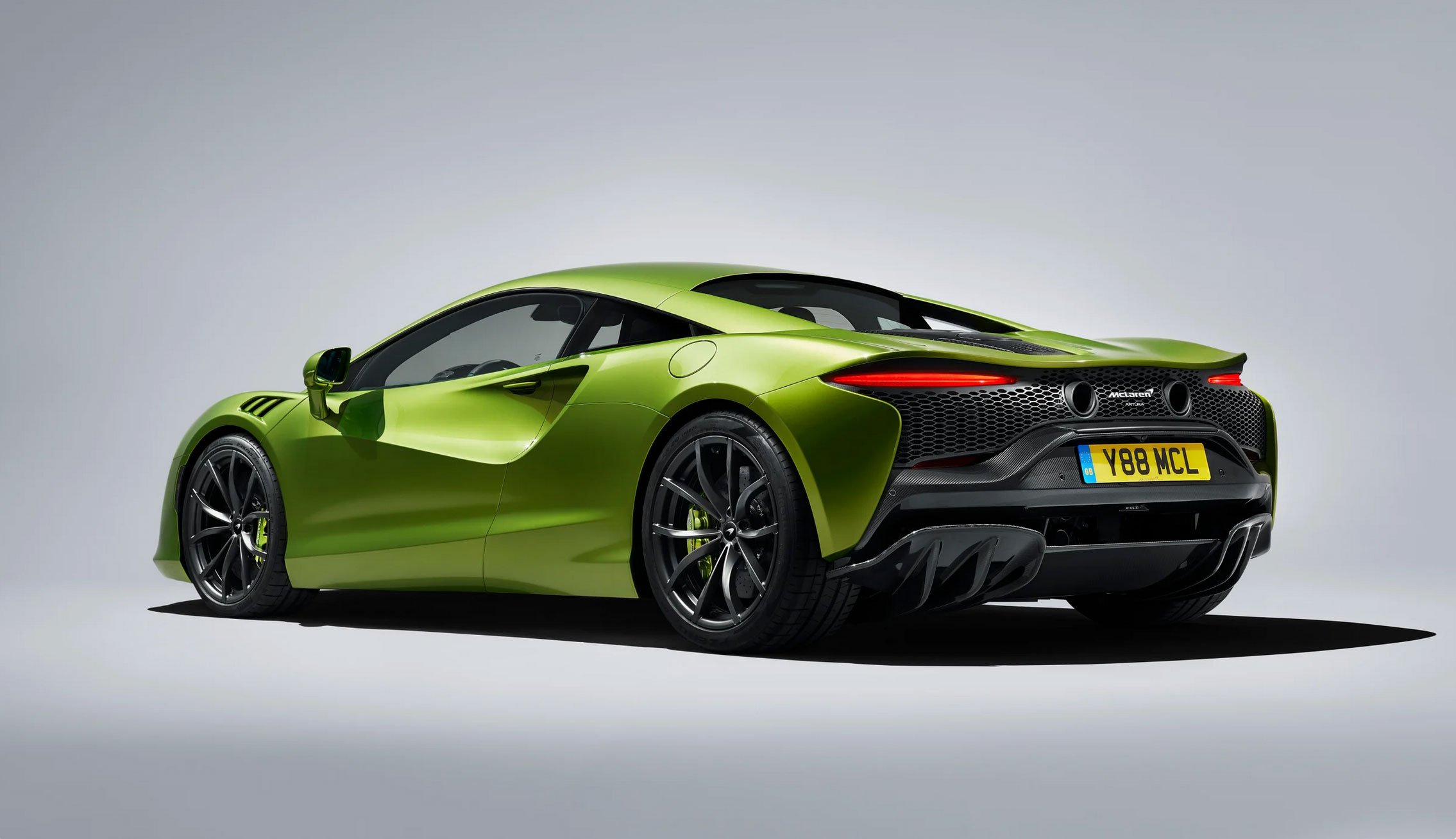 McLaren Automotive's High-Performance Hybrid super car in green shown against grey background.